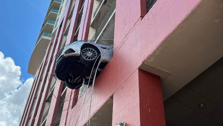 Car spotted dangling from parking garage in North Fla.